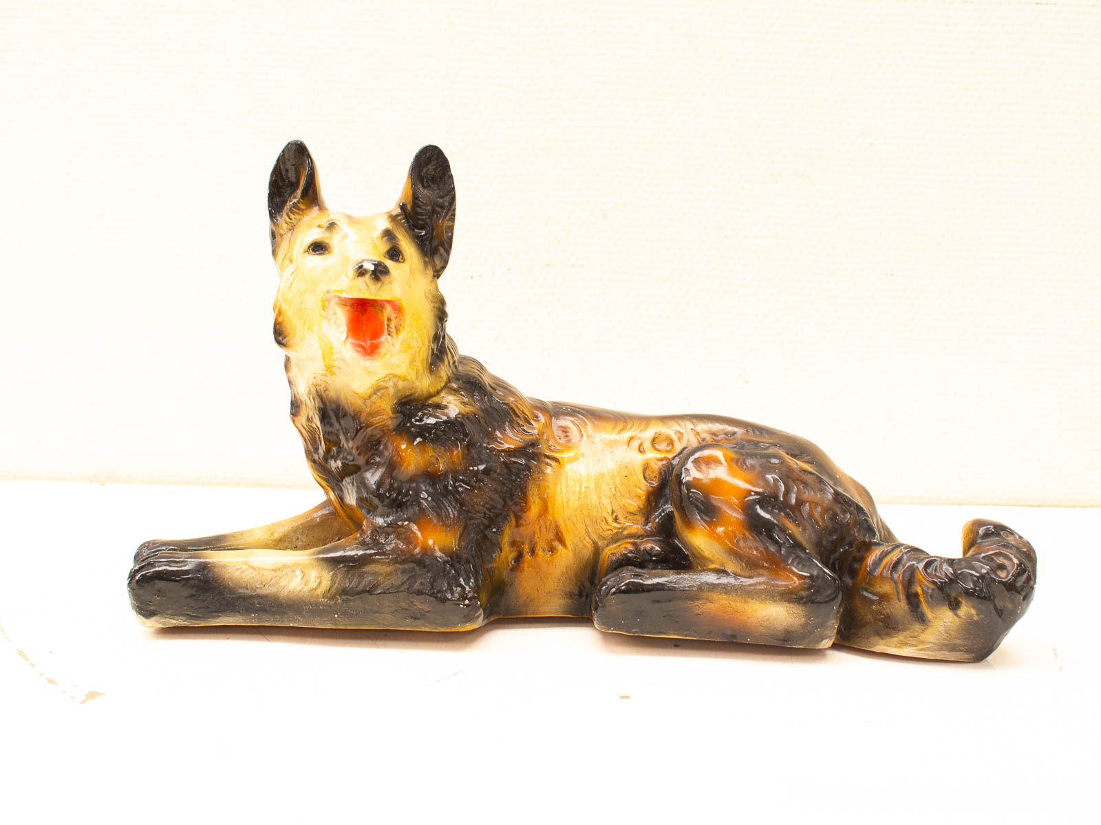 Vintage ceramic dog figurine in playful pose, perfect for pet lovers and home decor.