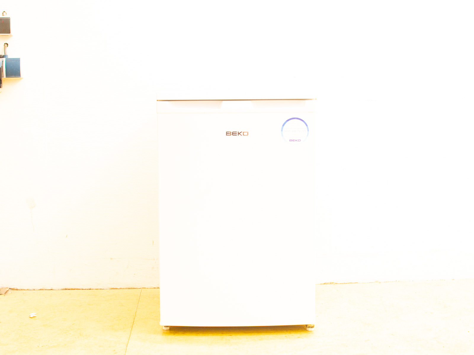 Sleek white Beko refrigerator, ideal for compact spaces with modern minimalist design.