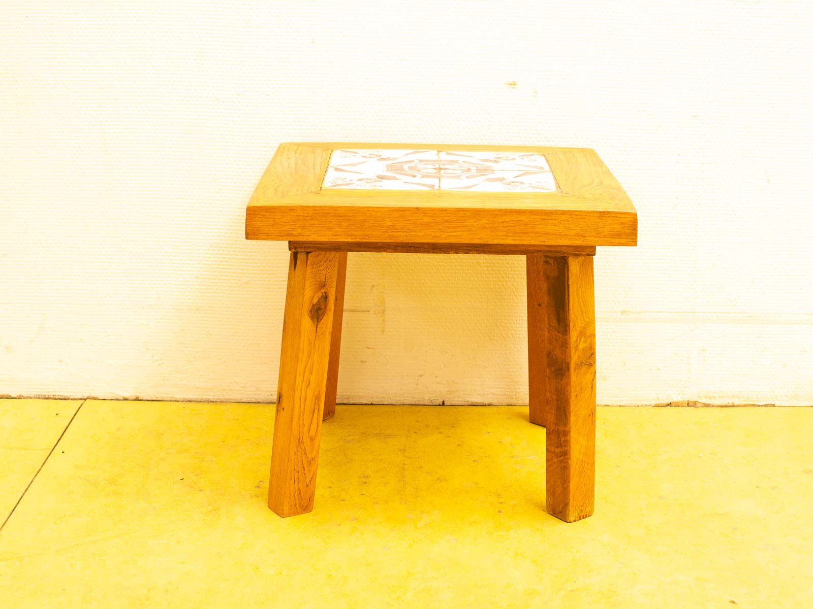 Vintage wooden table with inlaid tile; a timeless design for any living space.