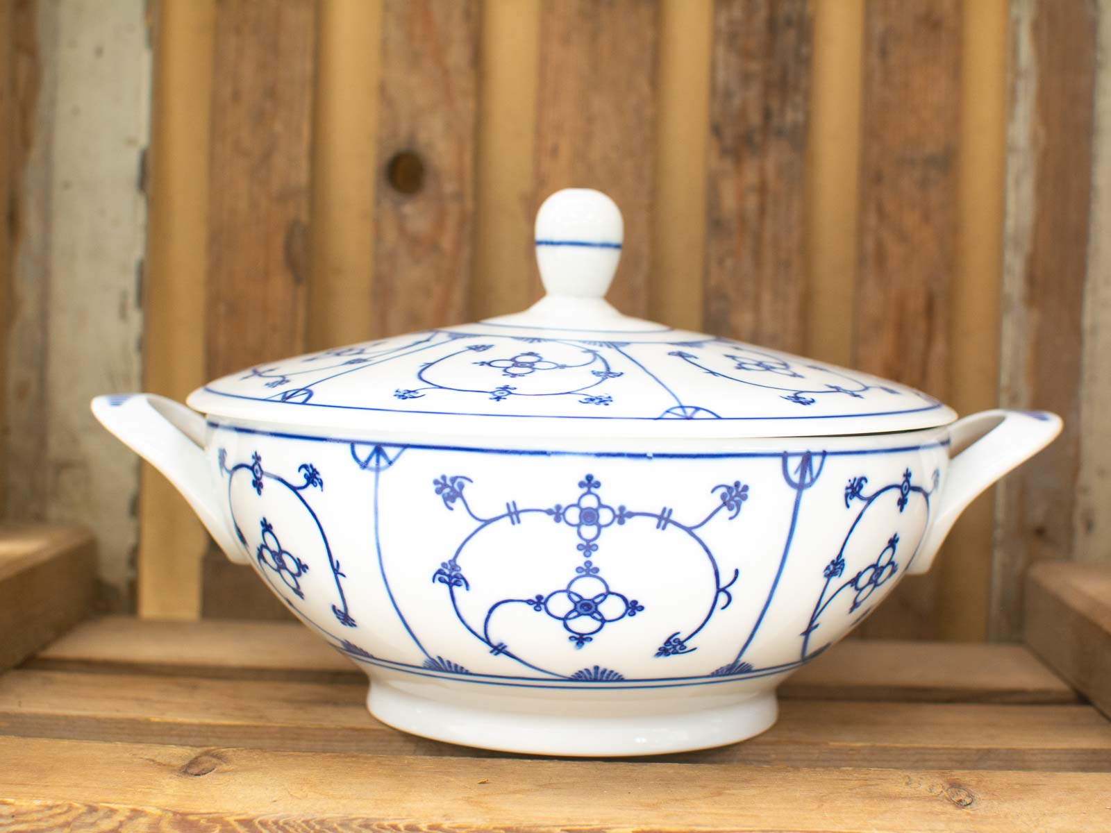 Elegant vintage porcelain tureen with intricate blue patterns, perfect for dining or decor.