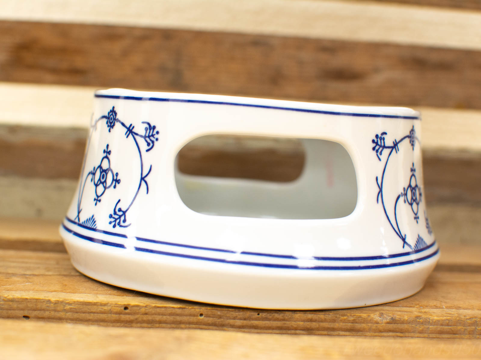 Elegant vintage porcelain bowl with blue motifs, perfect for serving or display.