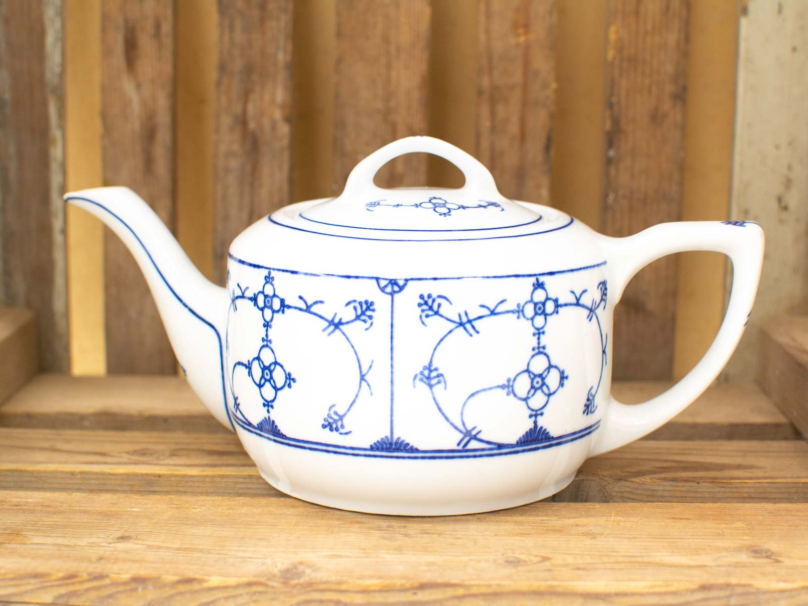 Elegant porcelain teapot with intricate blue floral design, perfect for tea lovers and stylish settings.