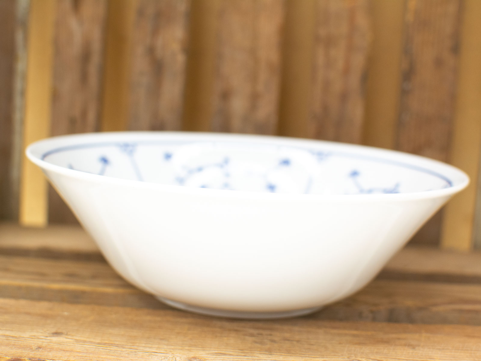 Elegant white porcelain bowl with blue floral design, perfect for any dining occasion.