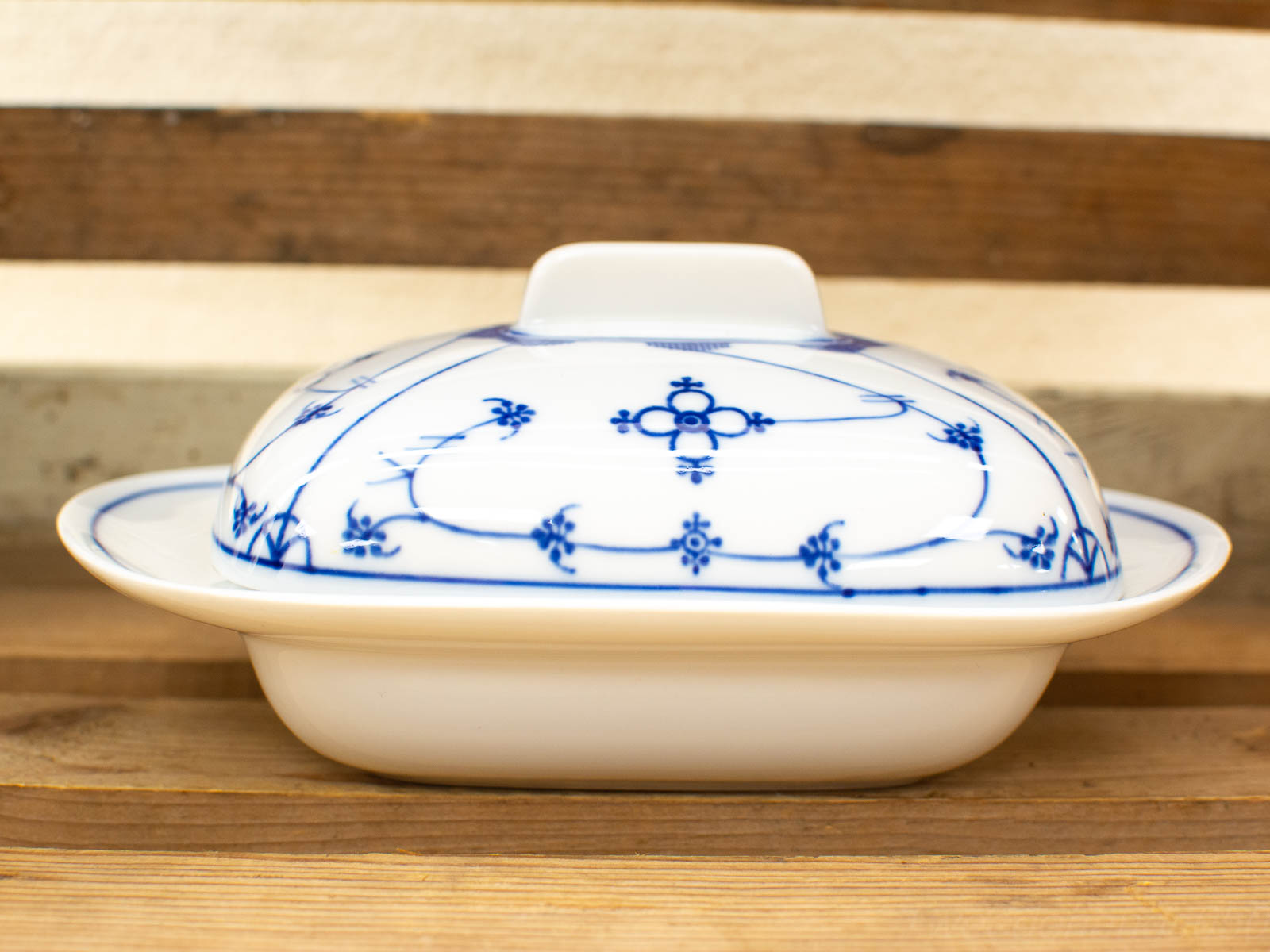 Elegant blue and white porcelain dish with lid, perfect for dining or decorative display.