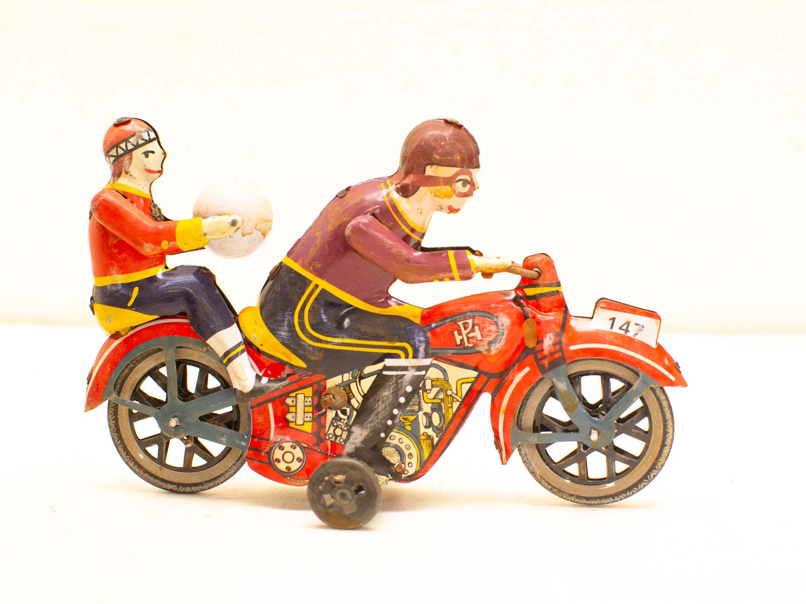 Vibrant vintage toy motorcycle with articulated riders in colorful outfits, perfect for collectors.