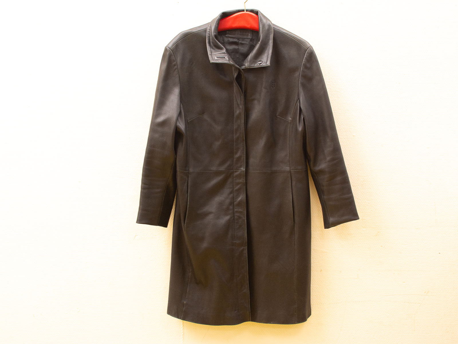 Sophisticated black leather coat with high collar, modern design, perfect for any occasion.