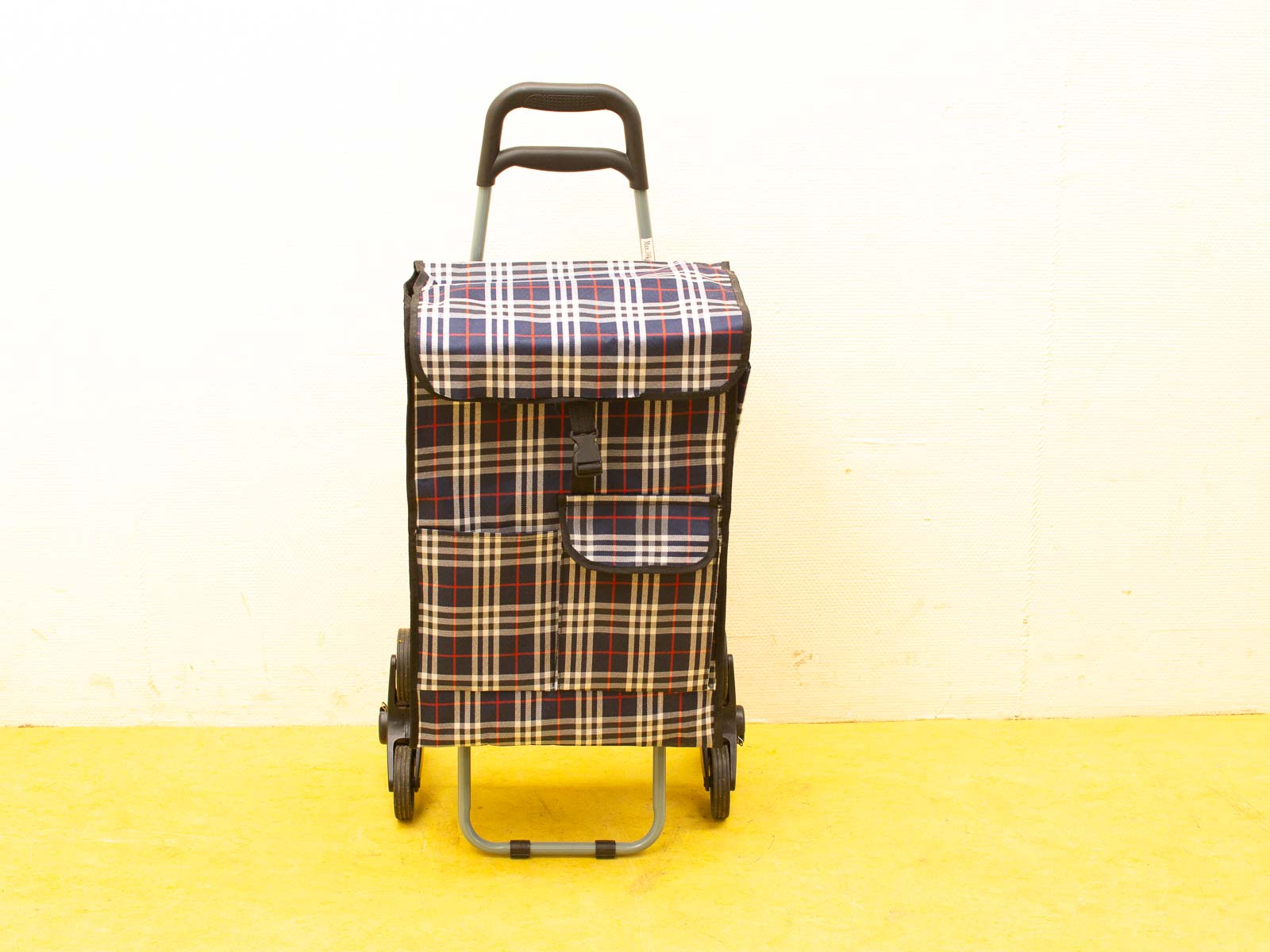 Stylish vintage plaid wheeled shopping cart in navy, white, and red for convenient shopping.