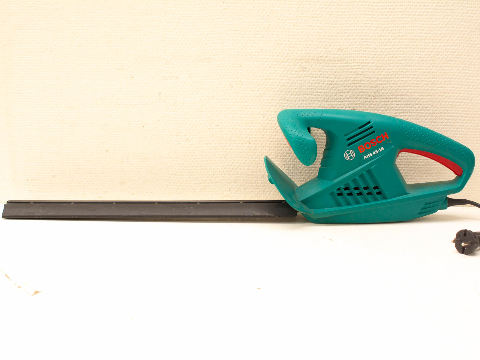 Bosch turquoise electric hedge trimmer for efficient, clean cuts in gardening and landscaping tasks.