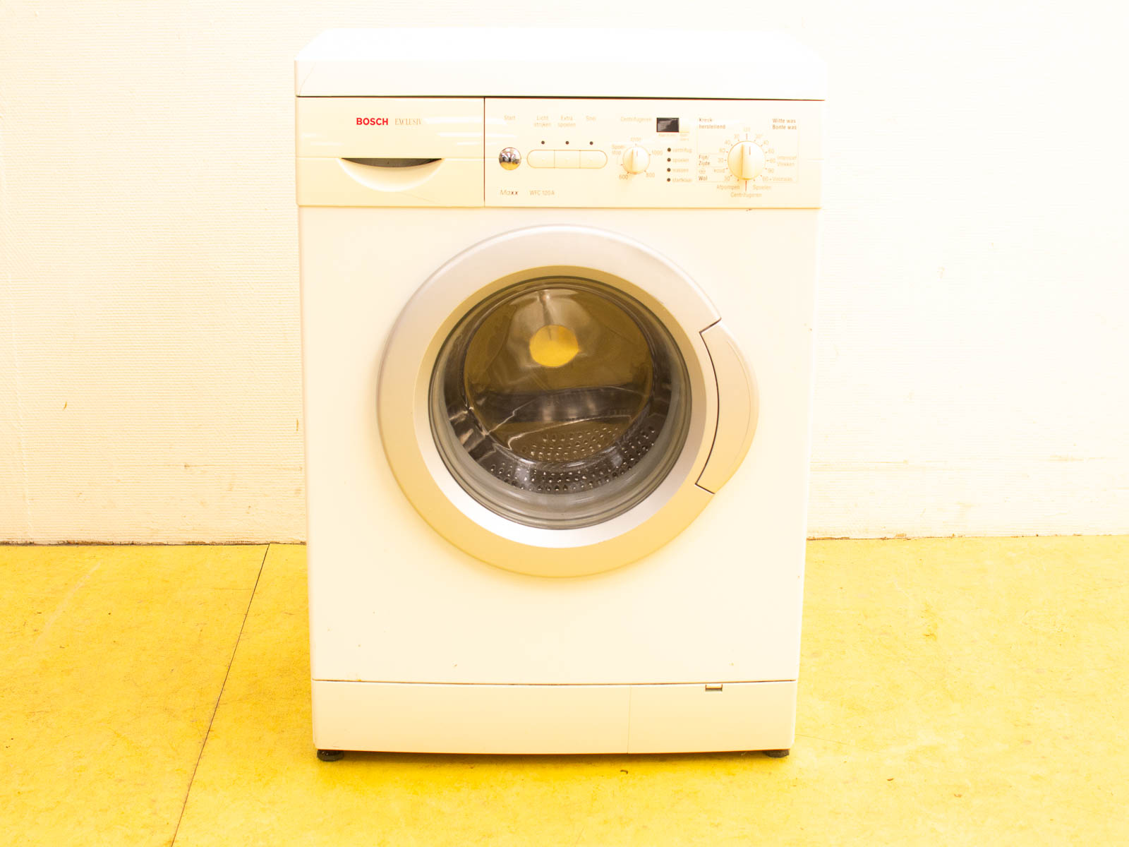 Sleek Bosch front-loading washing machine in white with glass door, ideal for any laundry space.