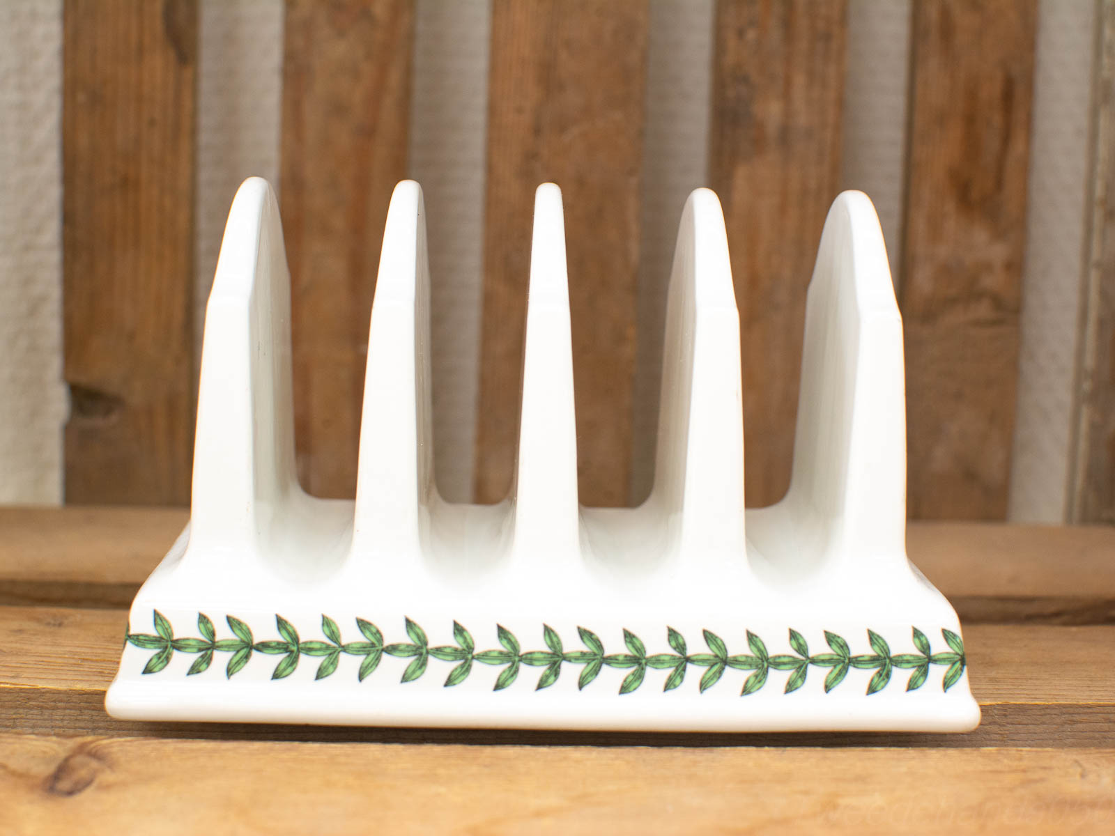 Elegant ceramic plate rack with leaf pattern, perfect for showcasing plates in any dining area.