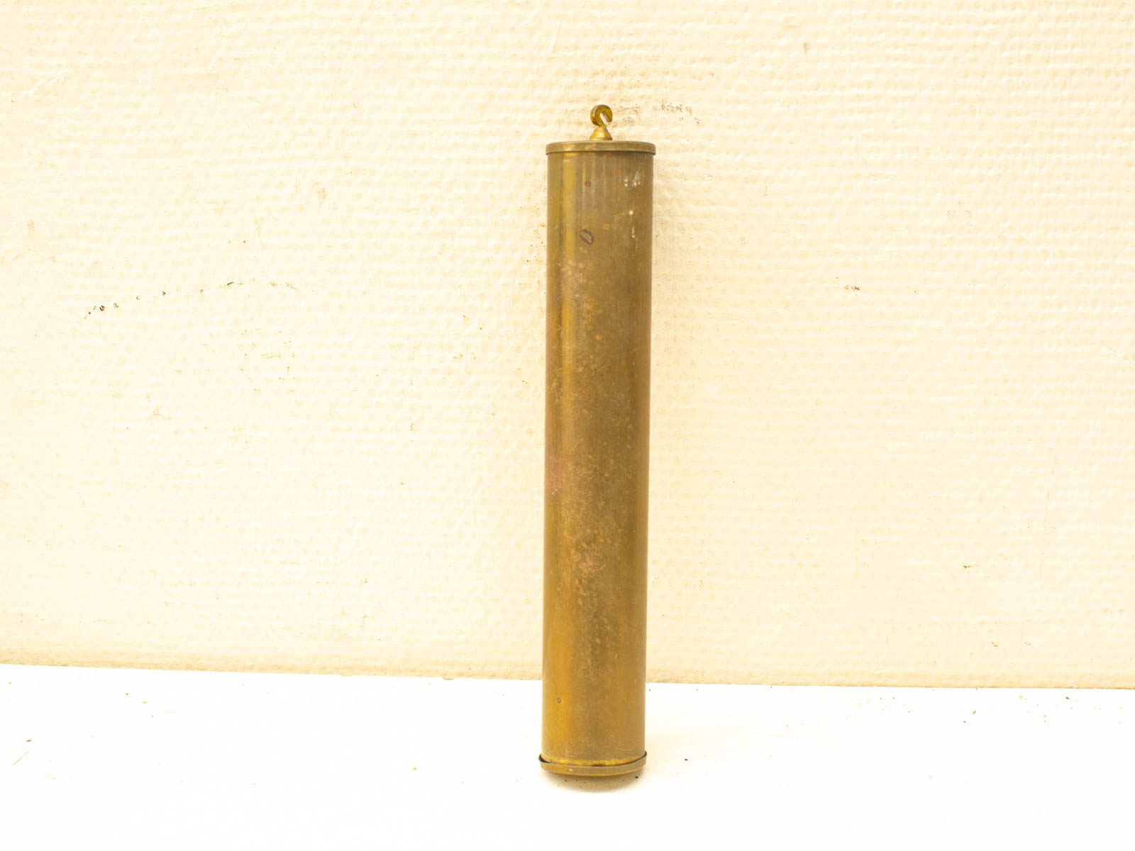 Vintage brass cylinder with hook, perfect for storage and decorative accents.