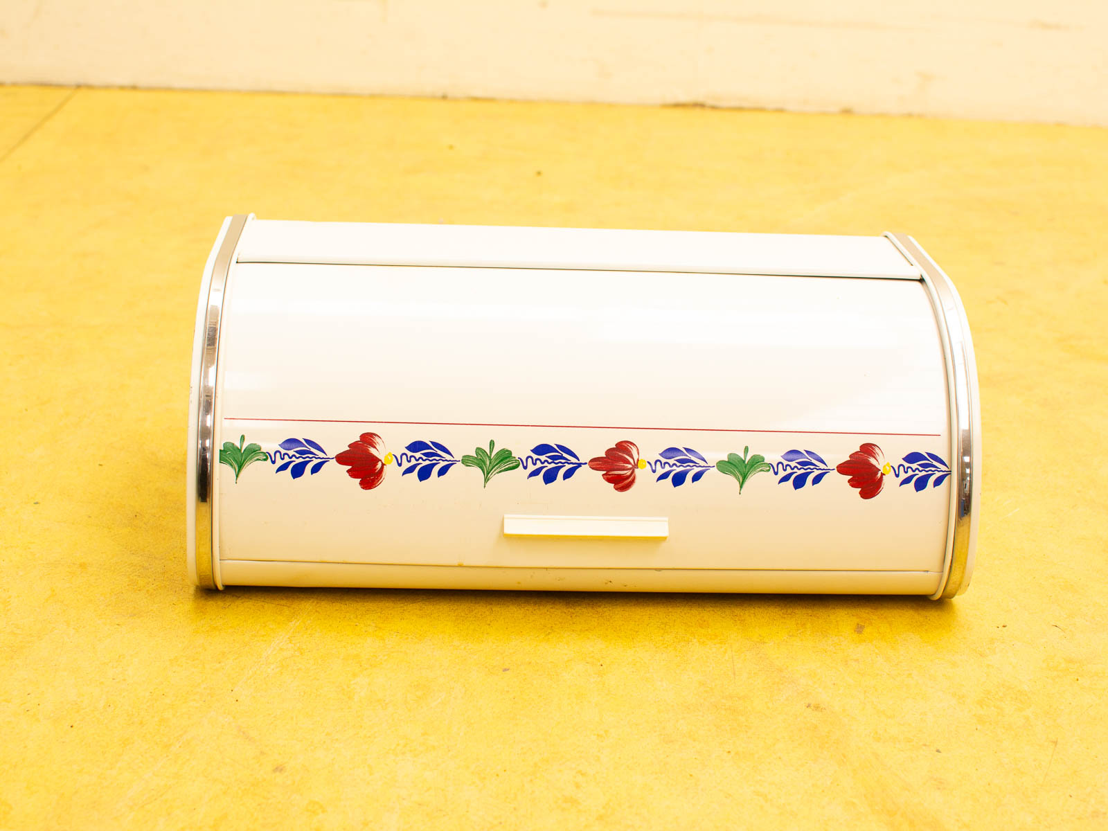 Charming vintage white bread box with floral design and chrome accents for stylish kitchen storage.