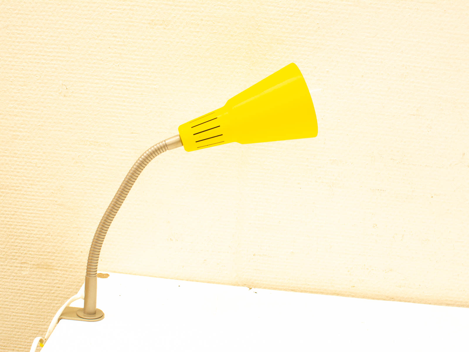 Bright yellow desk lamp with flexible neck, perfect for modern workspaces and reading areas.