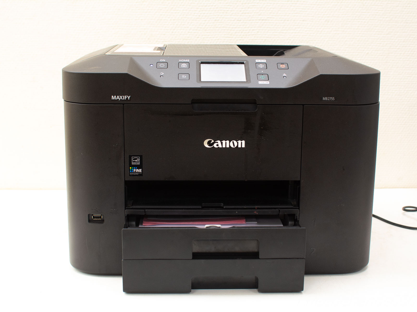 Compact Canon MAXIFY printer with sleek matte black design, ideal for home and office printing.