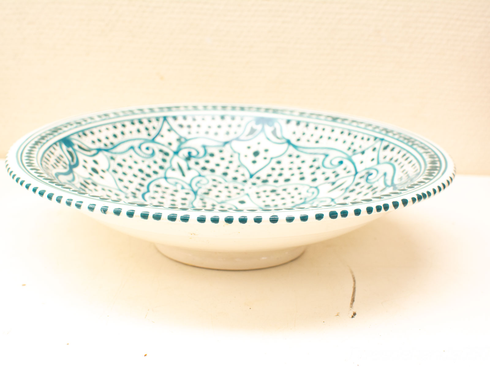 Turquoise-patterned ceramic bowl: elegant design for serving or decorative use.