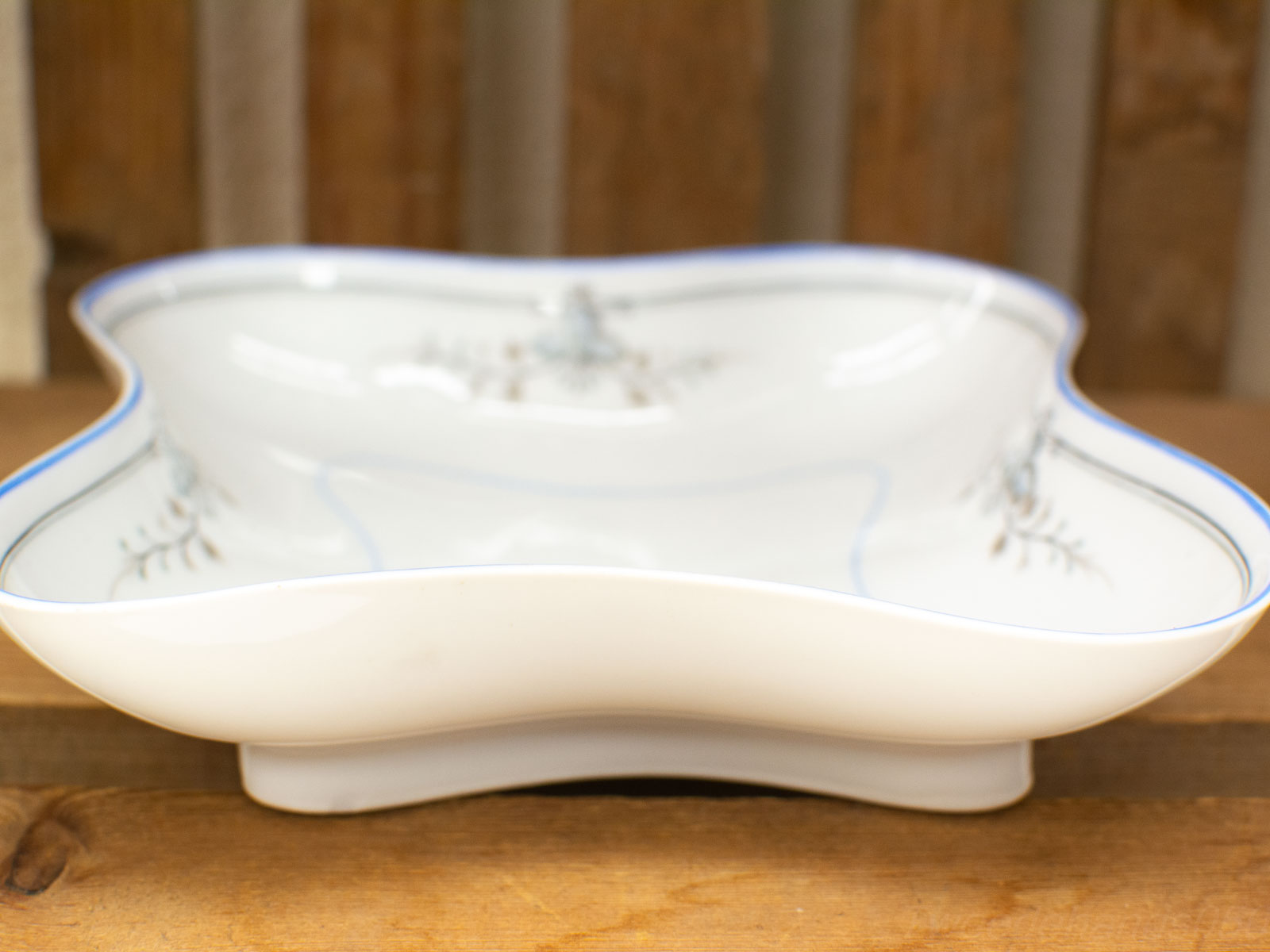 Elegant ceramic dish with blue botanical motifs, perfect for serving or display.