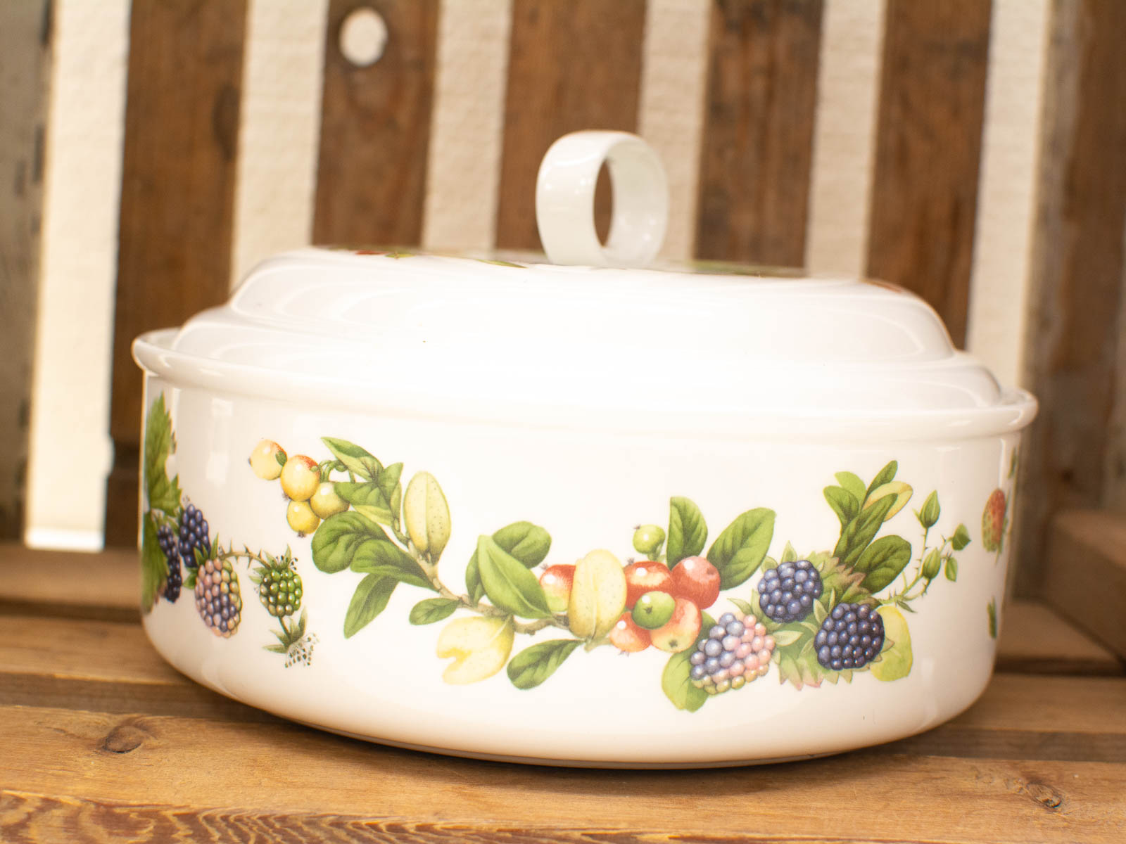 Beautiful hand-painted ceramic dish with vibrant fruit design, perfect for serving and storage.