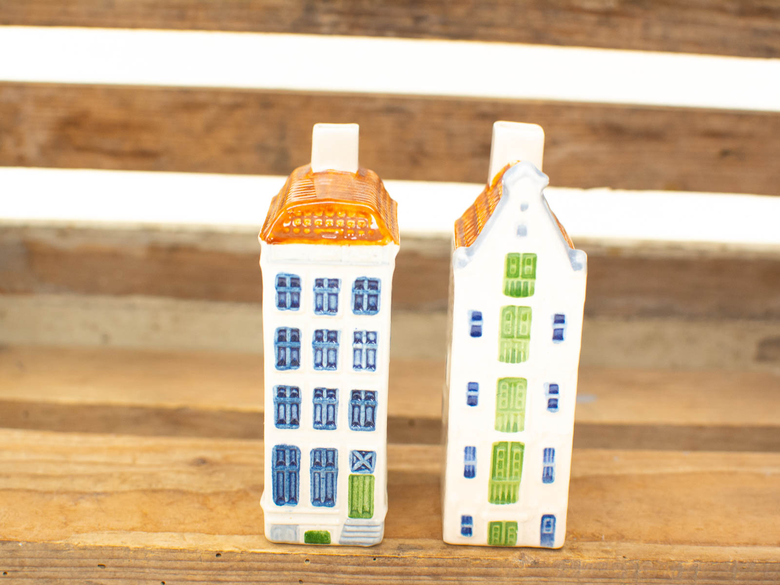 Vintage ceramic house figurines in blue and white, perfect for cozy home decor accents.