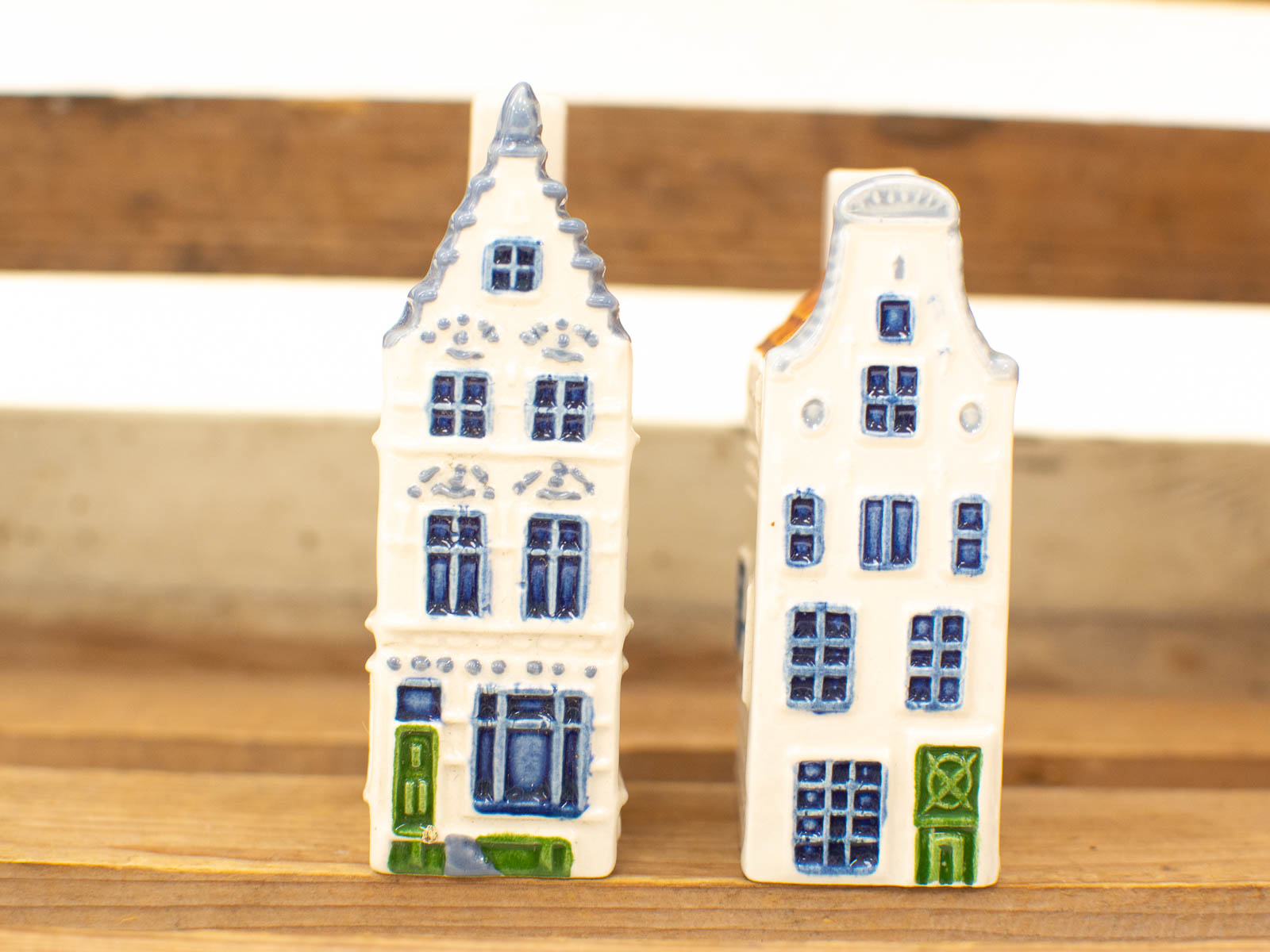 Charming ceramic houses with intricate details and vibrant blue and green accents.