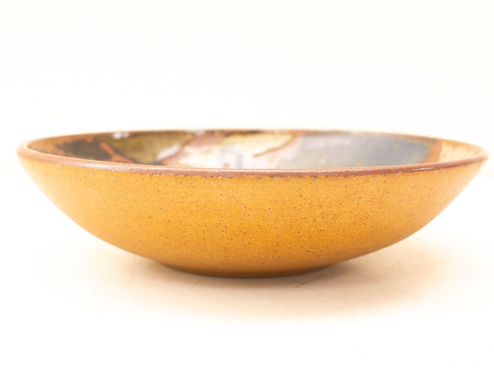 Stunning yellow ceramic bowl with intricate blue patterns, perfect for serving salads and pasta.