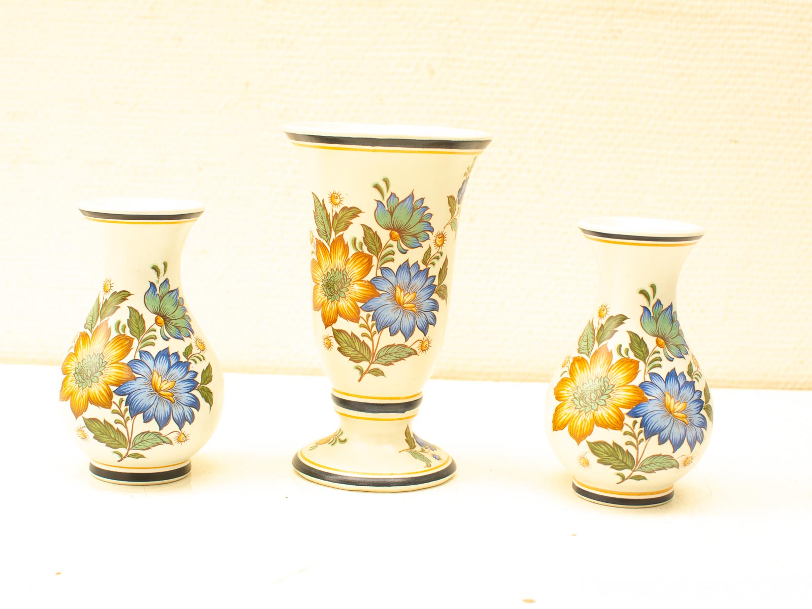 Charming ceramic vases with vibrant floral designs, perfect for enhancing any decor.