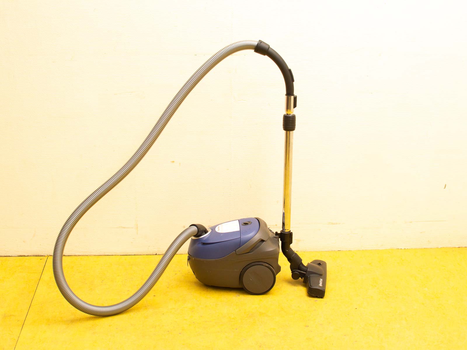 Compact blue vacuum cleaner with flexible hose for efficient and versatile cleaning in any space.