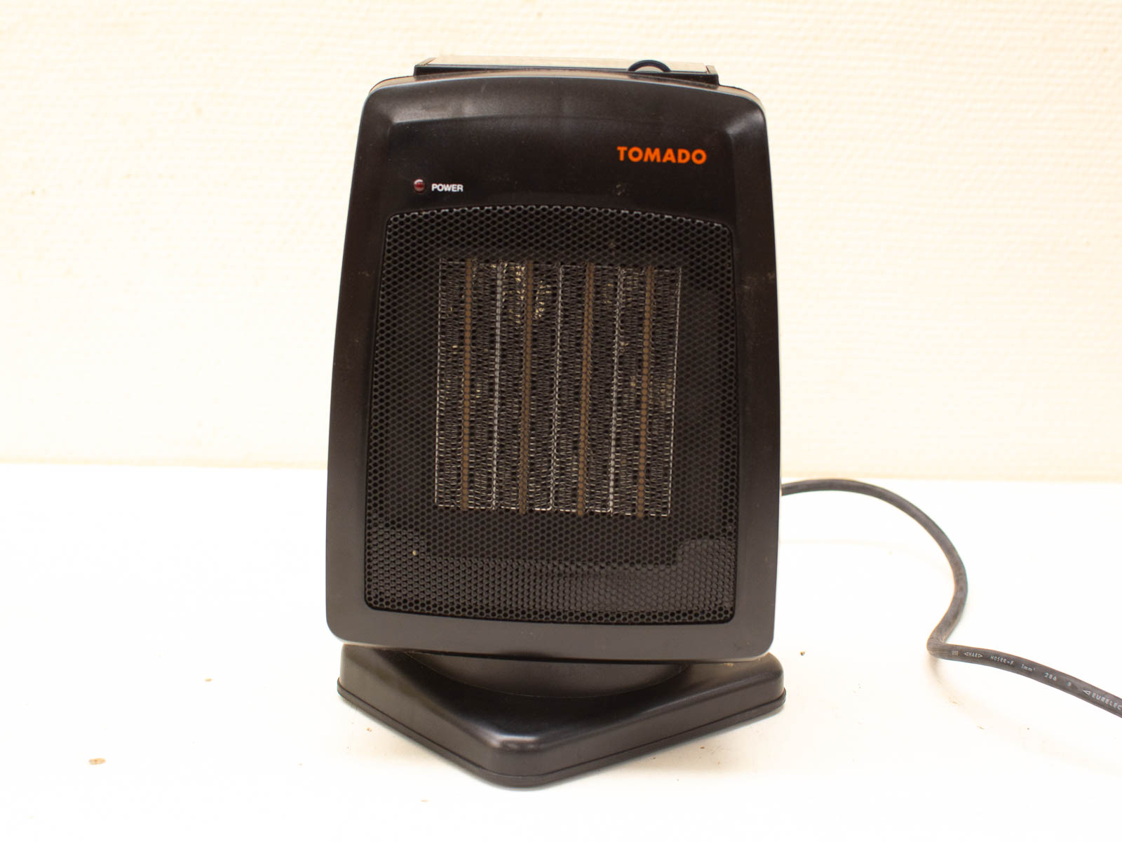 TOMADO Compact Black Electric Heater for efficient heating in small spaces like offices or bedrooms.