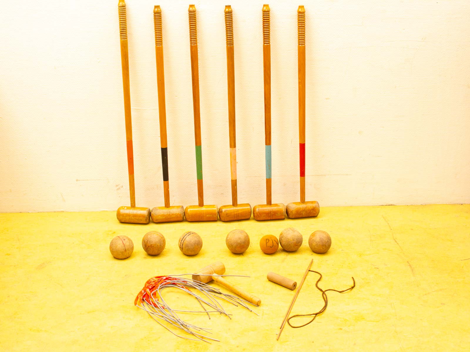 Quality used croquet equipment: wooden mallets, colorful balls, and essential accessories for outdoor fun.