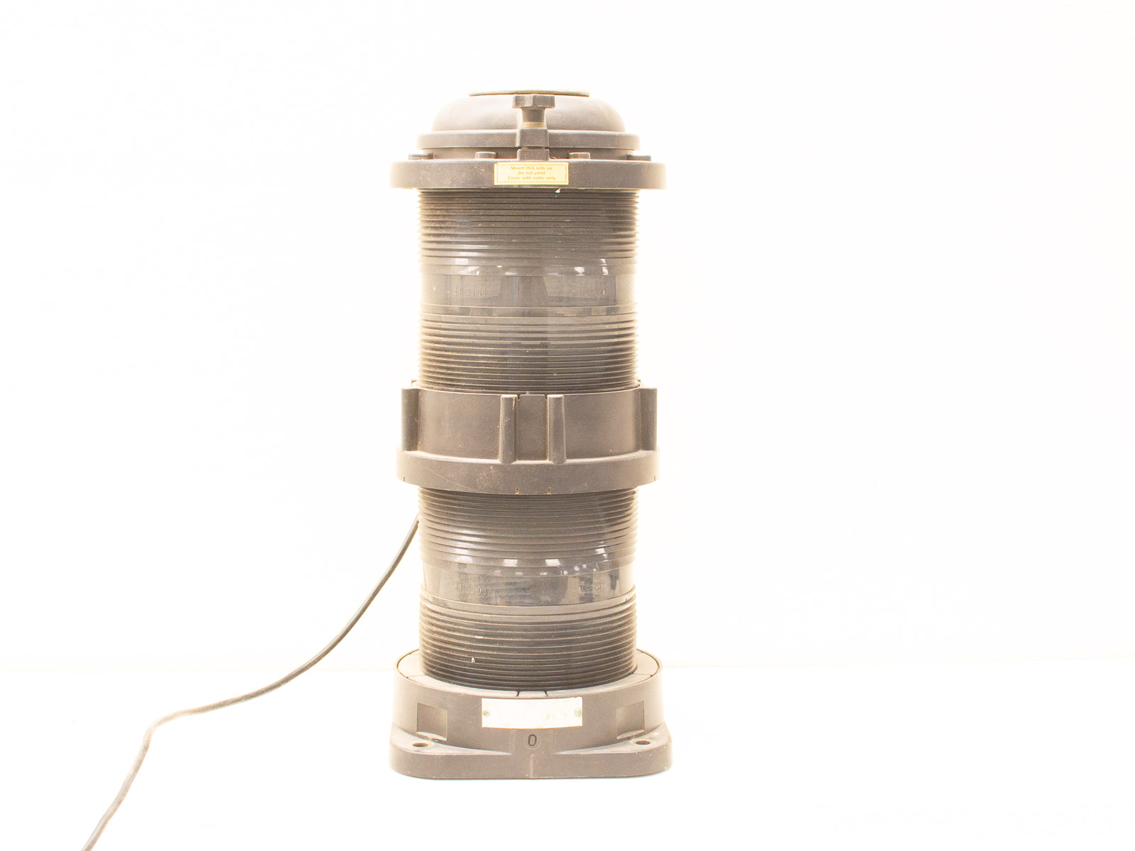 Cylindrical industrial device with power cord and control cap, designed for technical applications.