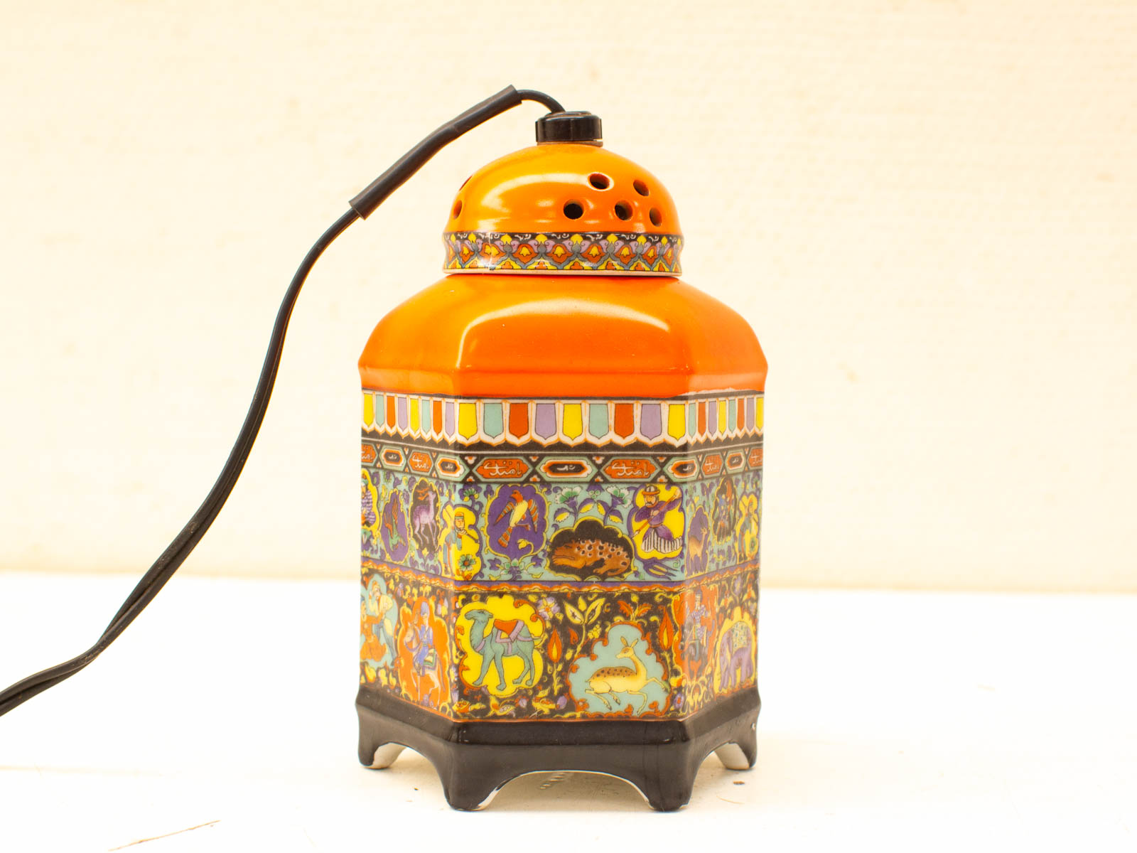 Vibrant hexagonal lamp with intricate hand-painted patterns, perfect for adding artistic flair to any room.