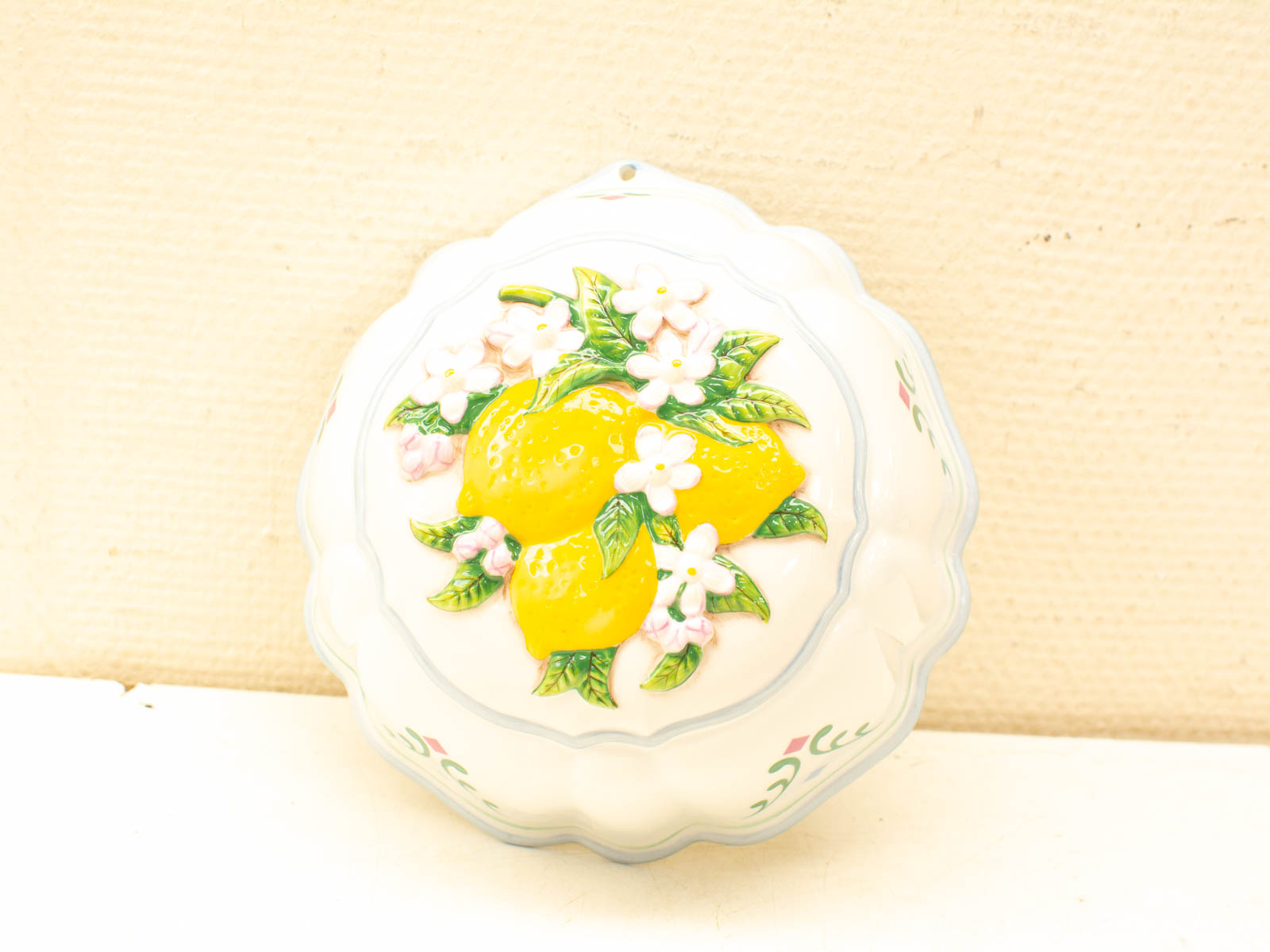 Charming ceramic dish featuring lemons and flowers, perfect for decor or practical use.