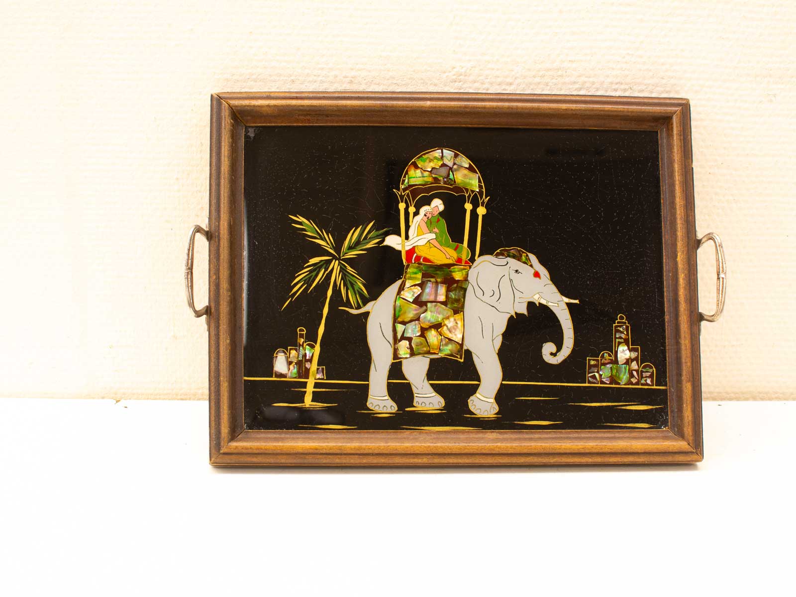 Elegant elephant and woman in palanquin on a vibrant decorative tray. Perfect for any space.