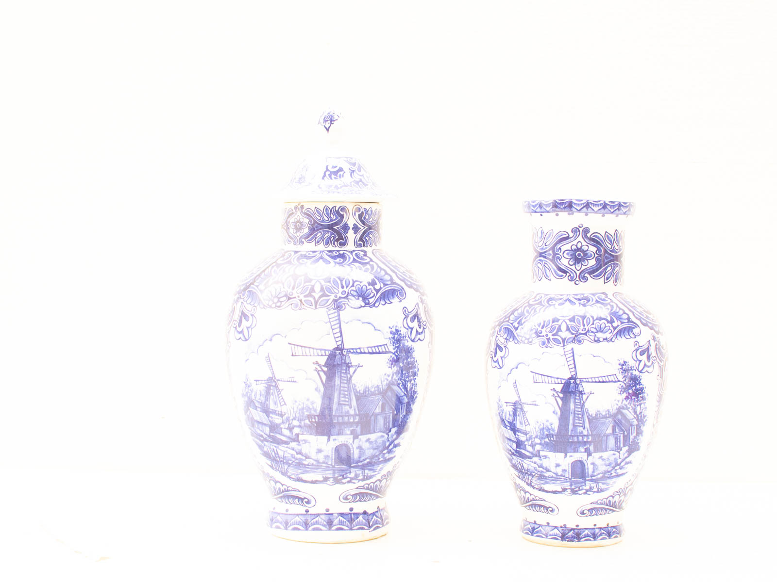 Elegant blue-and-white ceramic vases, featuring intricate windmill designs for timeless decor.