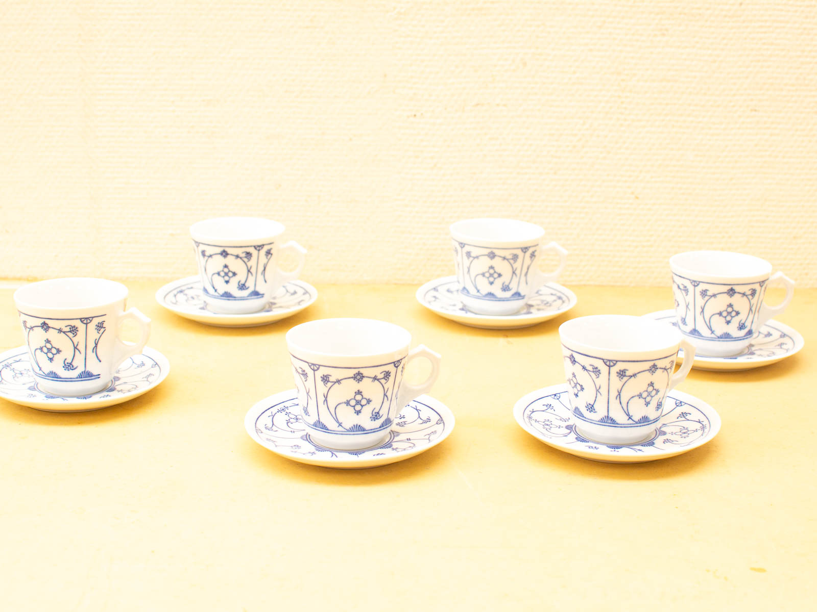 Elegant vintage blue-and-white tea cups and saucers, perfect for tea lovers and gatherings.