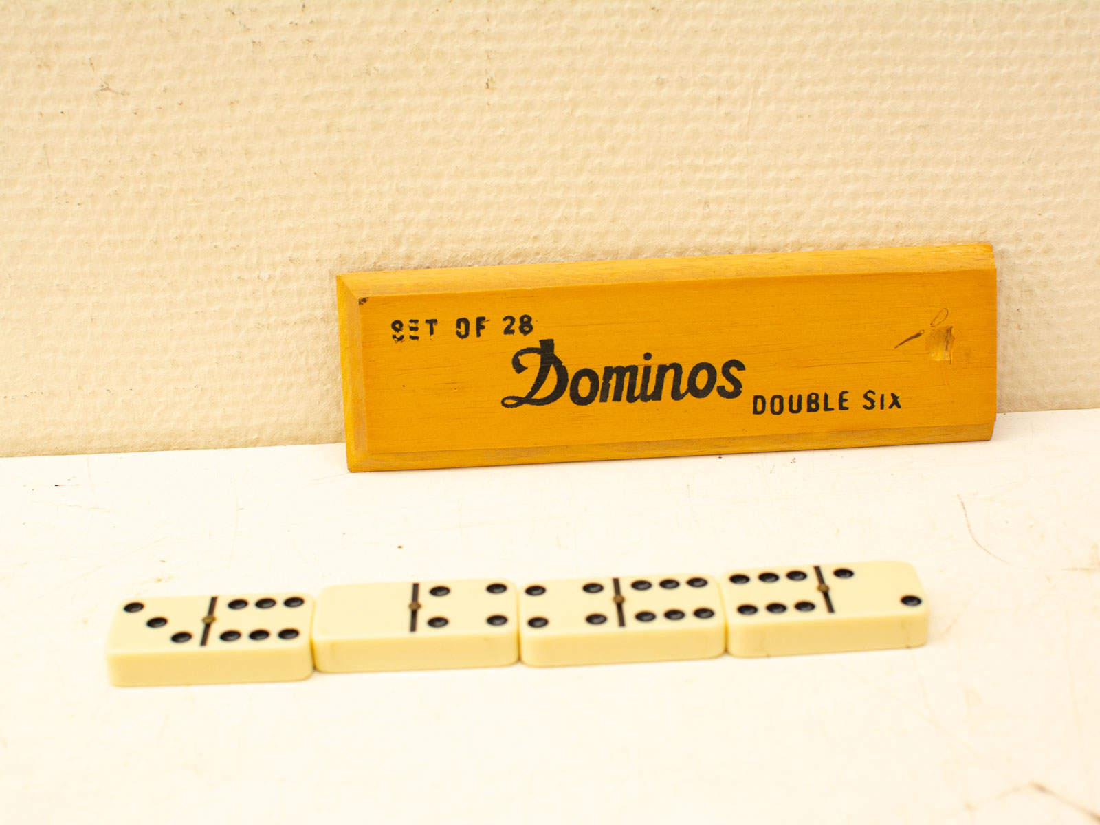 Vintage yellow domino set with 28 tiles for classic family game nights.