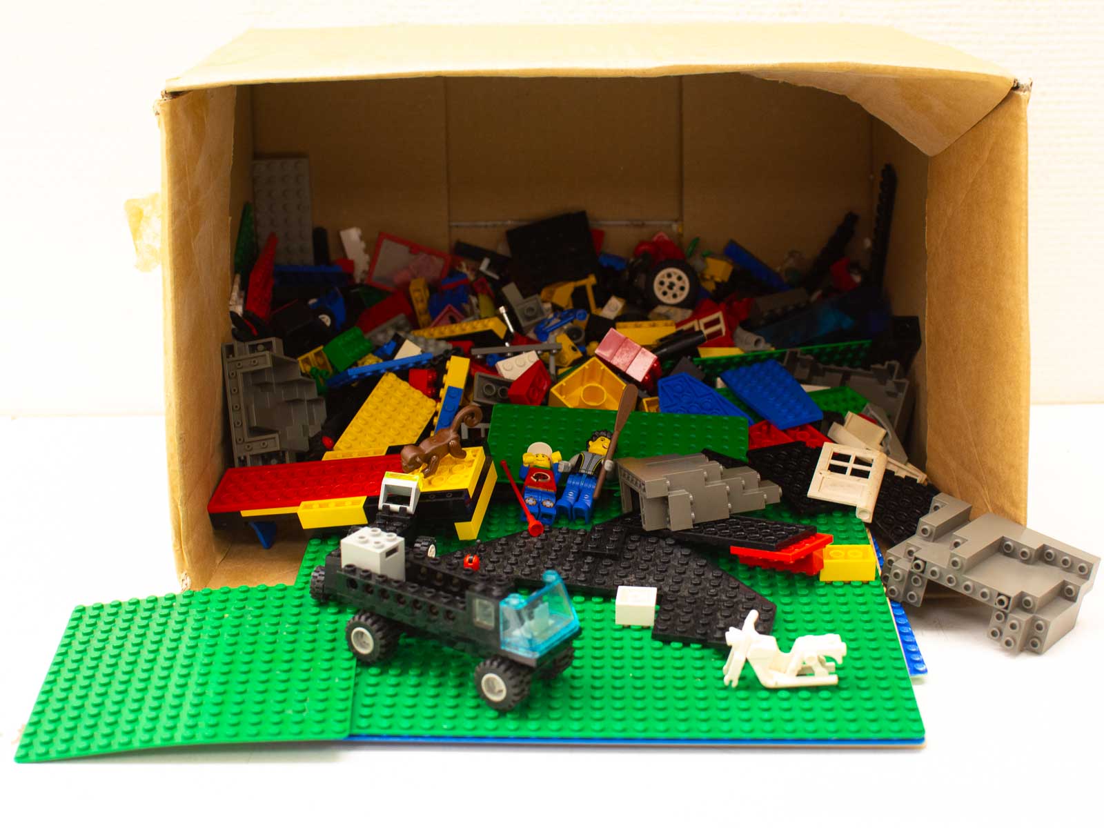 Colorful LEGO bricks in a cardboard box inspire endless creativity and imaginative building adventures.