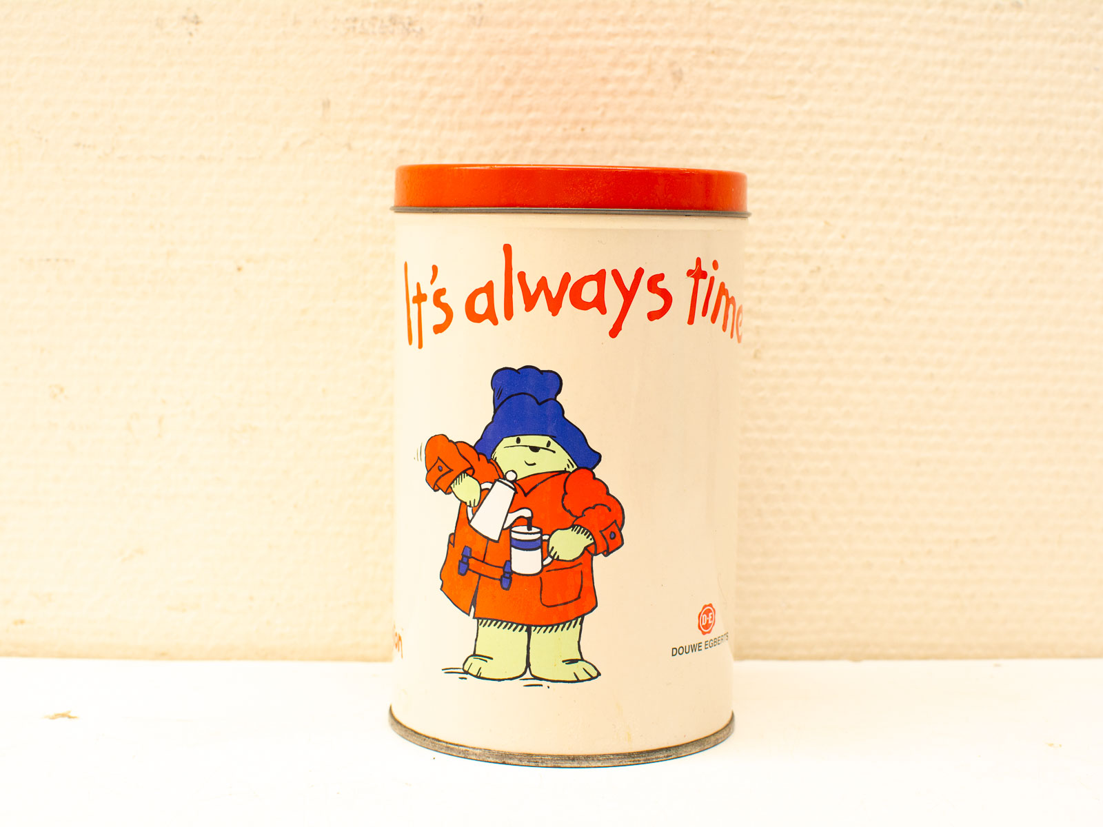 Playful vintage tin canister with colorful design, perfect for tea or decorative storage.