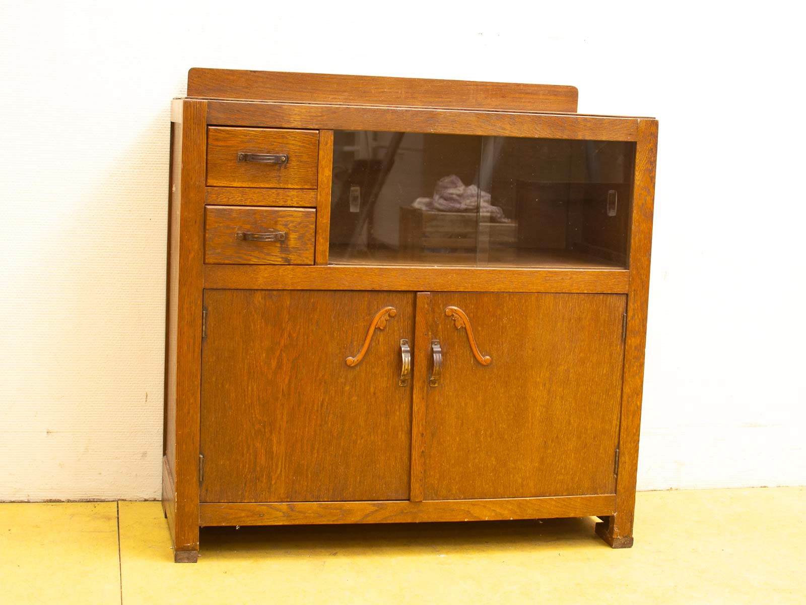 Timeless vintage wooden cabinet with glass doors and drawers for stylish storage and display.