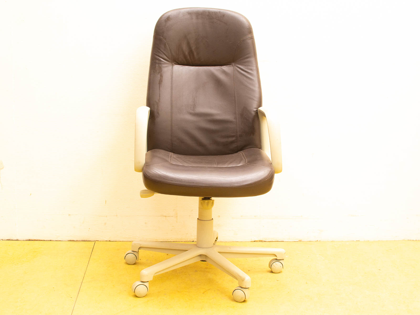 Elegant dark brown leather office chair with armrests, perfect for comfort and style in any workspace.