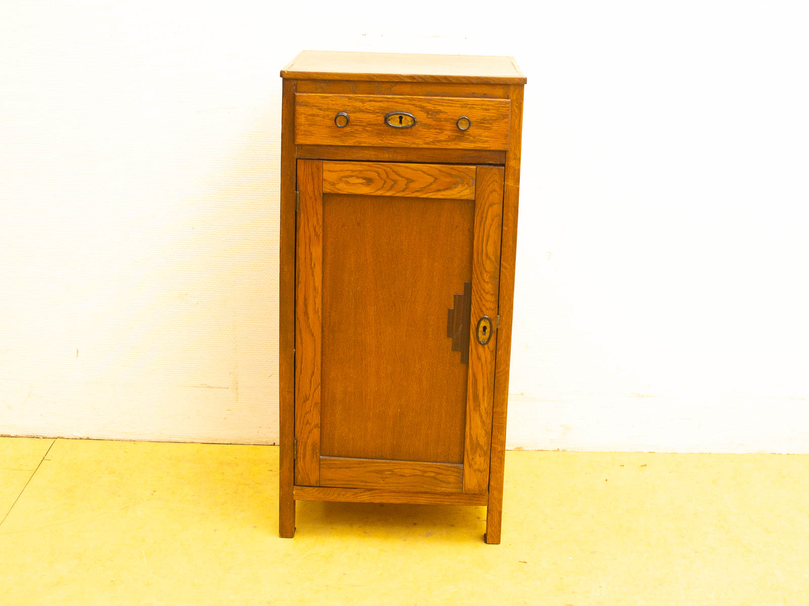 Vintage wooden cabinet with drawer and doors, perfect for rustic home decor.