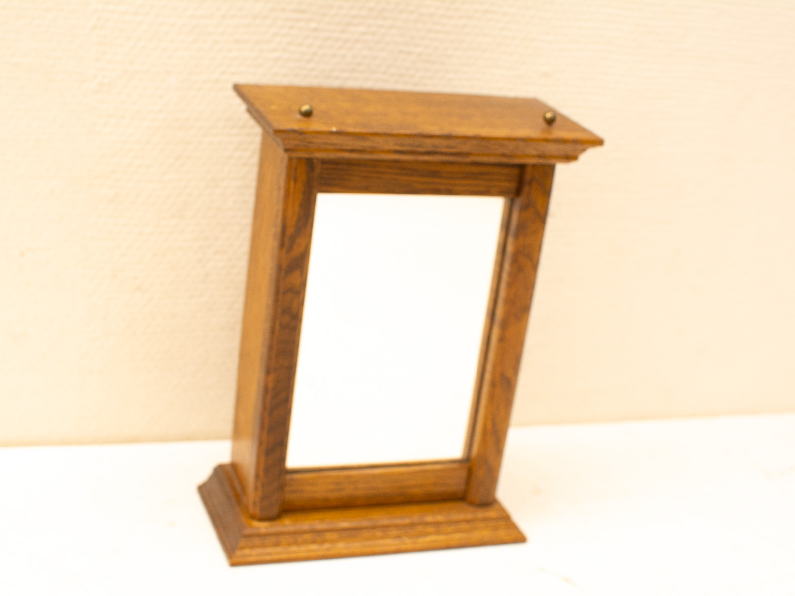 Timeless vintage wooden table mirror with elegant brass knobs and polished finish. Perfect decor piece.