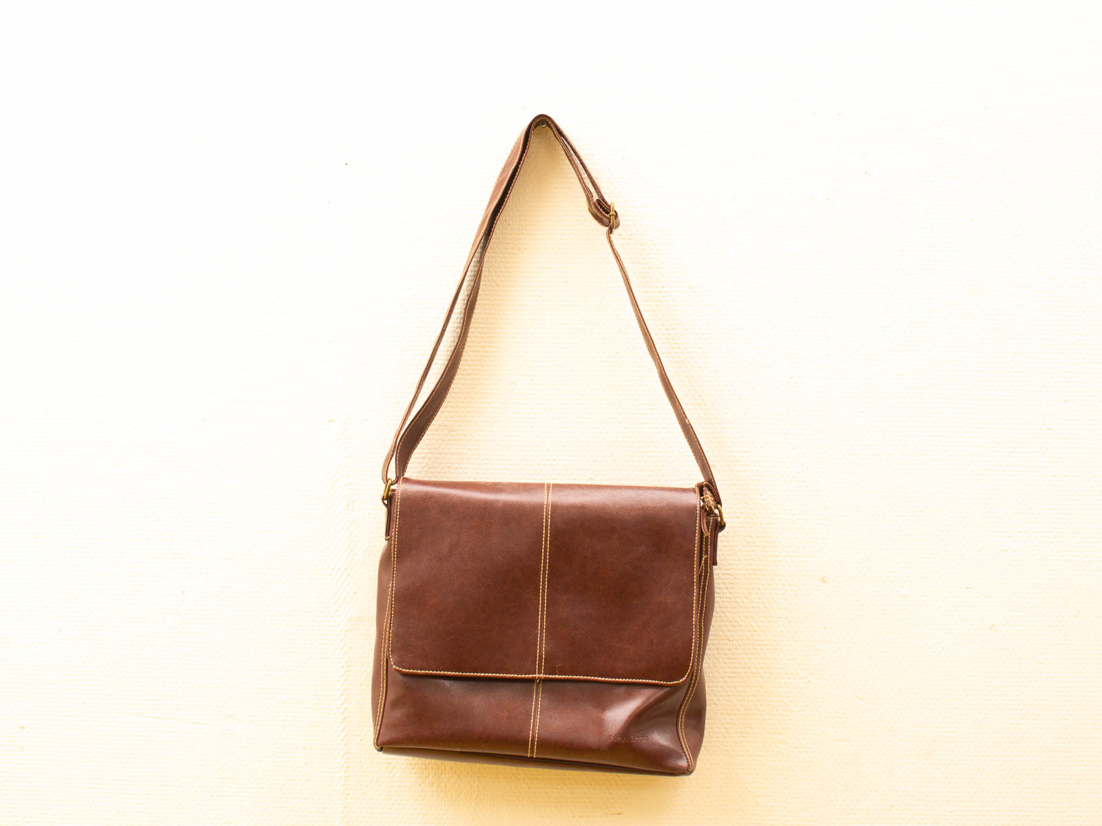 Timeless brown leather messenger bag for versatile style and functionality in any setting.