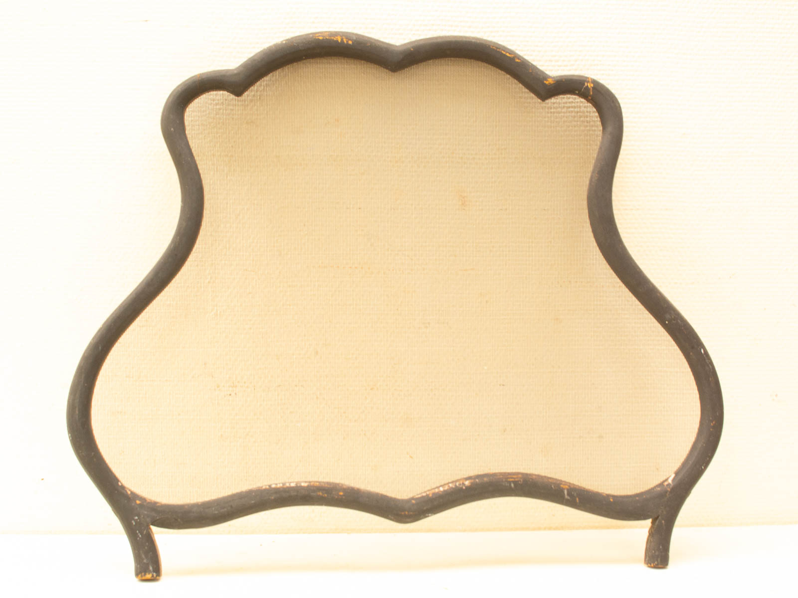 Vintage decorative frame with curvaceous design and textured cream background for cherished displays.