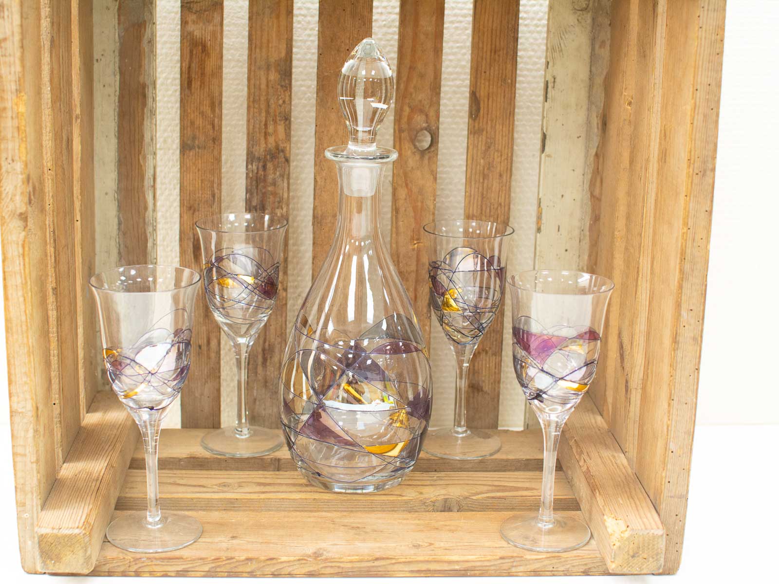 Elegant glassware set in a rustic wooden crate, perfect for festive gatherings and celebrations.