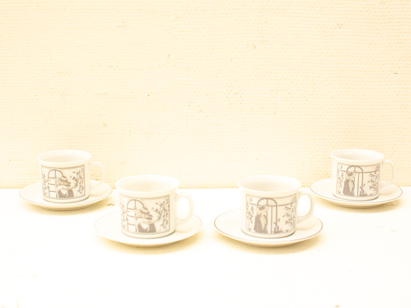 Elegant monochrome cups and saucers with intricate designs for a serene tea experience.