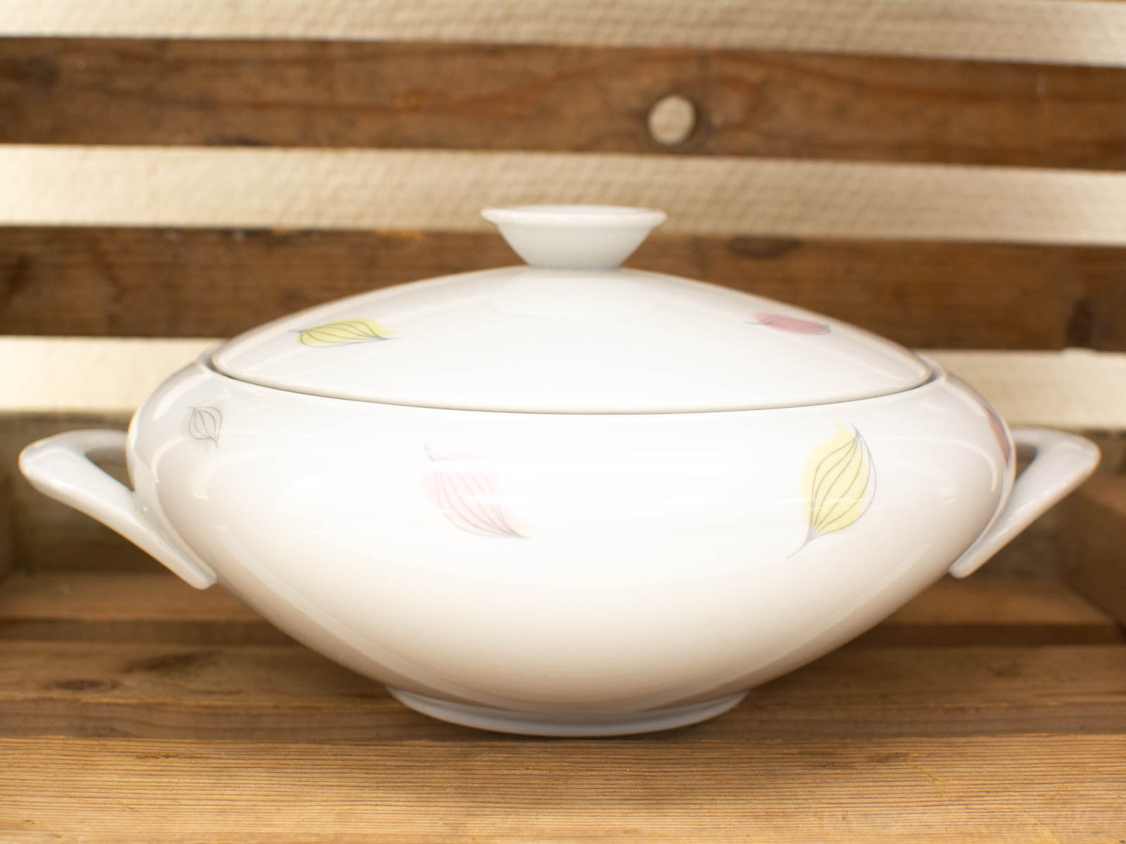 Elegant porcelain casserole dish with delicate pastel motifs, perfect for any dining occasion.