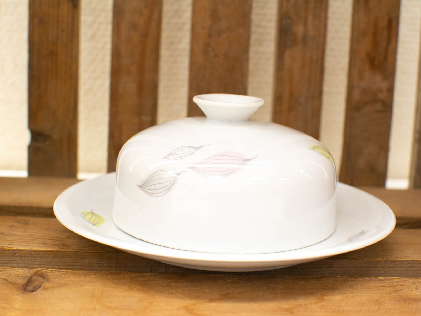 Elegant floral serving dish in glossy white porcelain, perfect for any dining occasion.