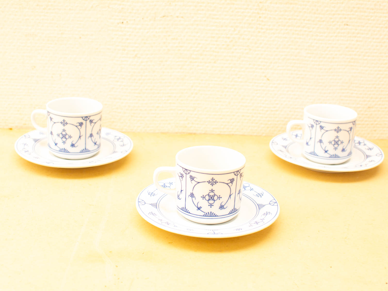 Elegant porcelain tea and coffee cup set with blue floral designs for warm gatherings.