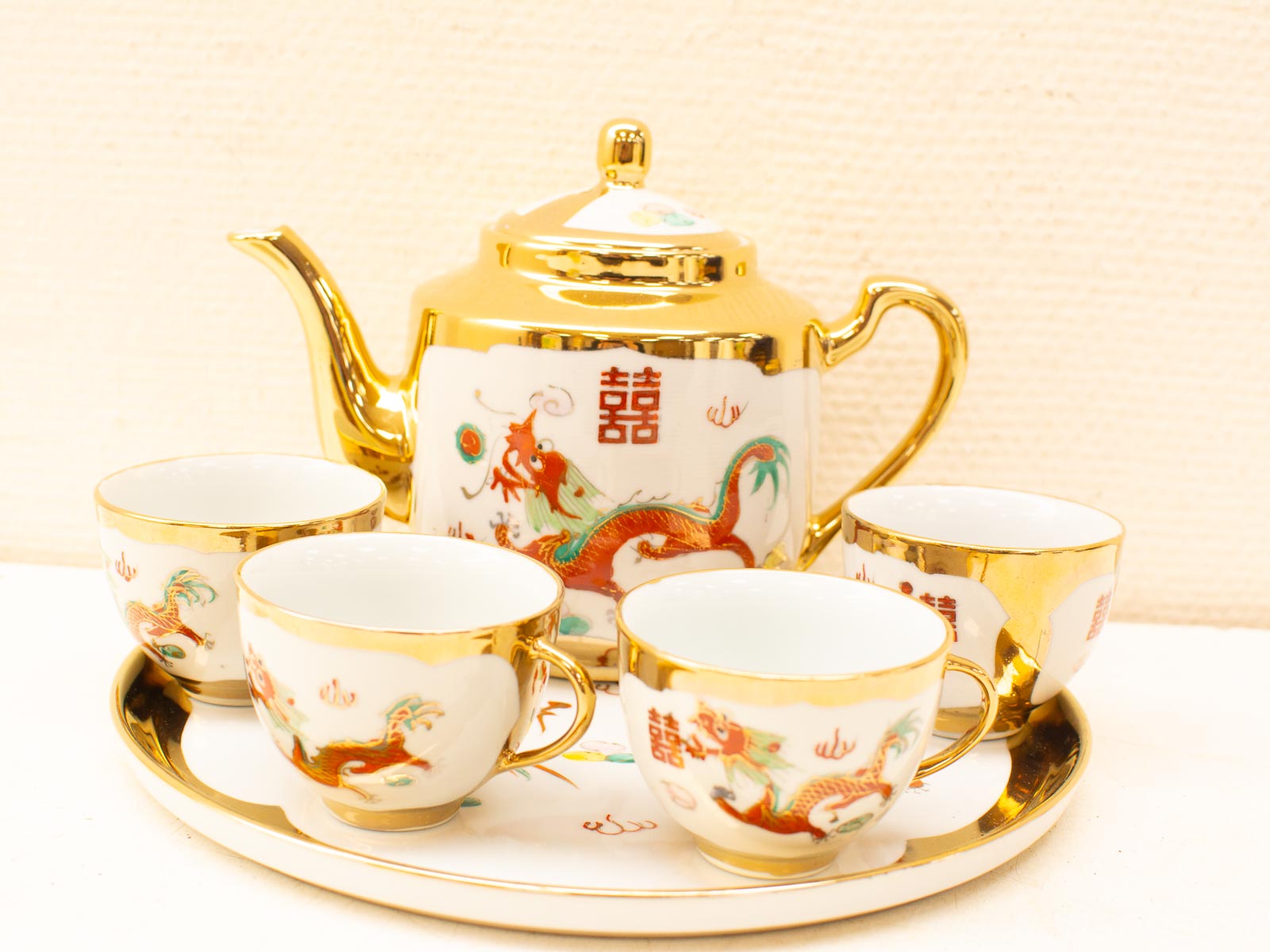 Elegant vintage tea set with dragon motif and gold accents, perfect for collectors and tea lovers.