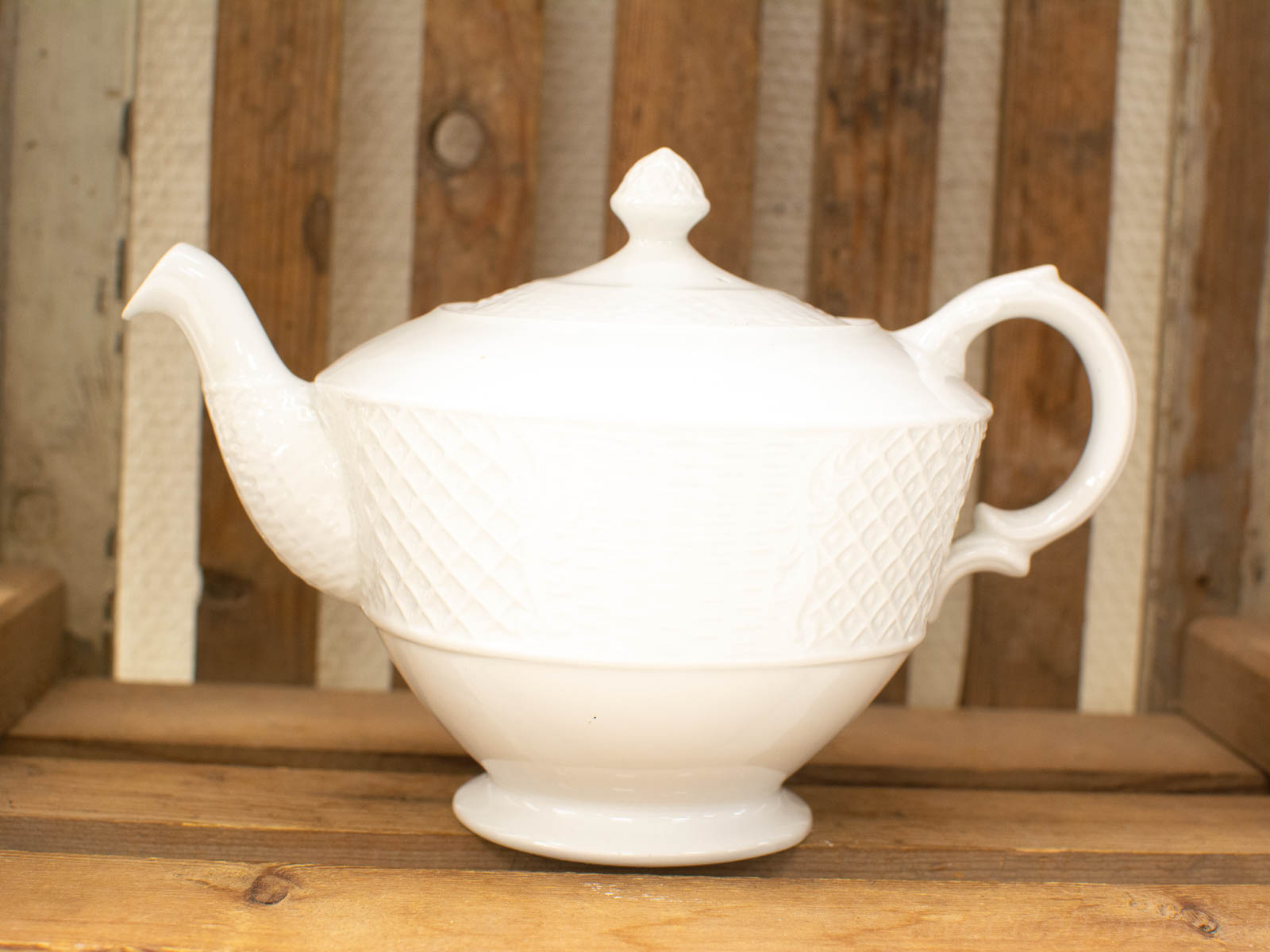 Elegant vintage white teapot with diamond pattern, perfect for charming tea gatherings.